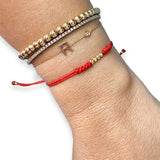 14K solid yellow gold adjustable red string bracelet with 3 D-cut gold balls styled in luxury bracelet stack on wrist