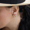 14K solid yellow gold huggie hoop earrings in two available sizes, featuring a smooth polished finish and classic everyday design.